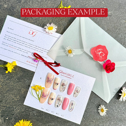 Nail art packaging with decorative nails, envelope, and letter on textured background.